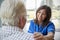 Over shoulder view of nurse on home visit with senior man