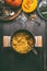 Over view of tasty pumpkin dish with rice in cooking pot on dark rustic kitchen table background, top view. Pumpkin risotto