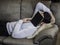 Over-worked, tired young man at home sleeping under book