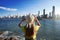 Overbuilding on the coast. Young woman with hat looking to skyline full of skyscrapers on south coast of Brazil