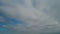 Overcast clouds dissipate into clear blue skies. Weather change. Time lapse.