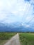 overcast clouds on the village rice field road