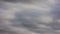 overcast gray clouds flowing horizontally - telephoto view time-lapse