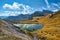 Overcast morning autumn alpine Dolomites mountain scene. Peaceful Valparola Path and Lake view, Belluno, Italy