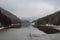 Overcast sky and thick fog rolls over coniferous trees above the Sance dam near the town of Ostravice, Czech Republic