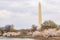 Overcast view of the Washington Monument with cherry blossom