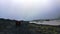 Overcast weather glacier hiking in Iceland volcanic black stone landscape with ice and snow