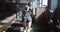 Overcoming difficulties. Back view young athletic woman pushing training sled exercising in large empty gym slow motion.
