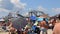 Overcrowded beach scene with roller coaster in background Maine