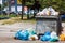 overfilled public trash bins at summer day in Bishkek, Kyrgyzstan