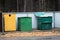 Overfilled trash of large wheelie bins for rubbish, recycling and garden waste