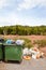 Overflowing bins next to Orange Orchard, Valencia region, Spain