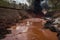 an overflowing chemical waste dump, spilling toxic substances onto the ground