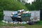 Overflowing dumpster at russian countryside in summer