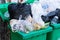 Overflowing garbage bins with household waste