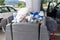 Overflowing garbage bins stuffed with trash from cars at a gas station