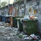 Overflowing garbage containers and bags clutter urban street corner