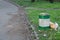 Overflowing green garbage bin in park