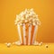 Overflowing popcorn in striped box against orange background, capturing a fun cinematic moment