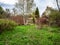 overgrown backyard in village on cloudy day