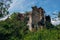 Overgrown ruins of abandoned school with bullet marks, consequences of war in Abkhazia