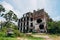 Overgrown ruins of abandoned school with bullet marks, consequences of war in Abkhazia