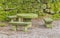 Overgrown stone benches and table