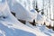 Overhanging beautifully curved snow caps on a fence in sunlight.Soft focus. Snowy winter concept