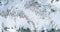 Overhead aerial top view over winter snowy mountain rocks.Rocky mountains covered in snow and ice glacier.Winter wild