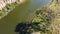 Overhead aerial view of 2 people fishing in a murky river from their kayaks on a sunny day, Werribee river