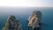 Overhead aerial view of Faraglioni from a drone, Capri. Famous rocks of Campania, Italy