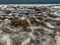 Overhead capture of Atlantic Ocean waves breaking on the sand beach shoreline