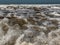 Overhead capture of ocean waves breaking on the sand beach shoreline