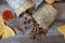 Overhead of a carne asada beef burrito cut in half with meat spilling out of it.