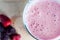 Overhead Close Up of Pink Berry Smoothie with Frozen Fruits on W