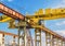 Overhead crane cabin at a construction site on a background of industrial zone