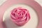 Overhead detail of pink rose frosted cupcake