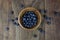 Overhead Display of Fresh Blueberries in a Rustic Wood Bowl