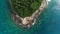 Overhead drone shot of tops of palm trees and turquoise sea water in Ko Pu island in Phuket, Thailand. Abstract texture, place for