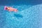 Overhead Drone Shot Of Woman On Summer Holiday Floating On Inflatable Airbed In Swimming Pool 