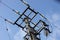 Overhead electricity pole against a blue sky