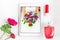 Overhead of essentials on white background:, laptop, pomade, flower, perfume, pad, tablet