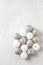 Overhead flat lay shot of a group of Christmas Tree ornaments on a light gray surface with copy space
