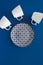 Overhead flat lay view of clean tableware plate and white coffee cups on dark blue background