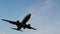 Overhead flying airplane on blue sky