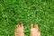 Overhead photo of feets on grass background.