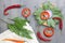 An overhead photo of sliced red onion, chilli peppers, linen napkin and bay leaves on the table. Top view. Laurel leaves and vario