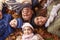 Overhead Portrait Of Family Lying In Autumn Leaves