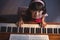 Overhead portrait of girl playing piano in classroom