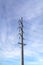 Overhead power line against peaceful cloudy sky